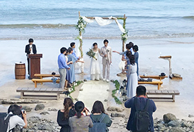 青い海を背景にさわやかな結婚式です